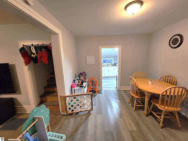 dining space with hardwood / wood-style flooring