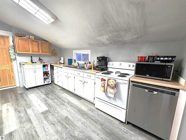 kitchen with white cabinetry, light hardwood / wood-style flooring, stainless steel appliances, and lofted ceiling