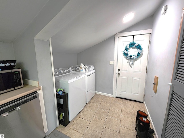 laundry area with light tile patterned flooring and washing machine and clothes dryer