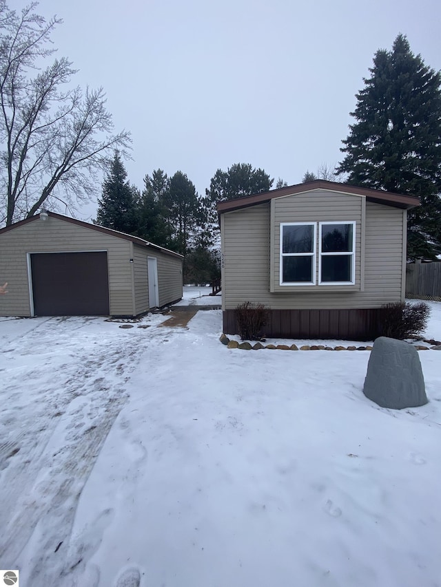 exterior space with a garage and an outdoor structure