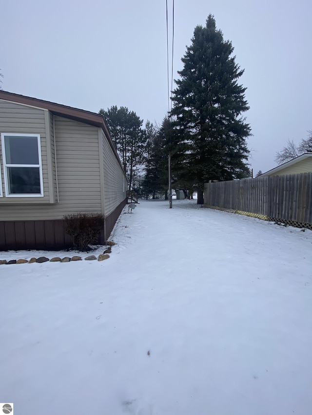 view of yard layered in snow