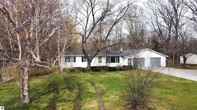 ranch-style house with a garage and a front lawn