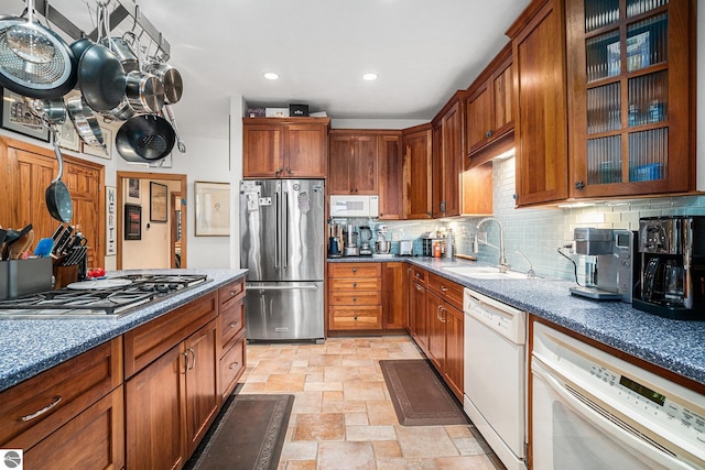 kitchen featuring backsplash, sink, and appliances with stainless steel finishes