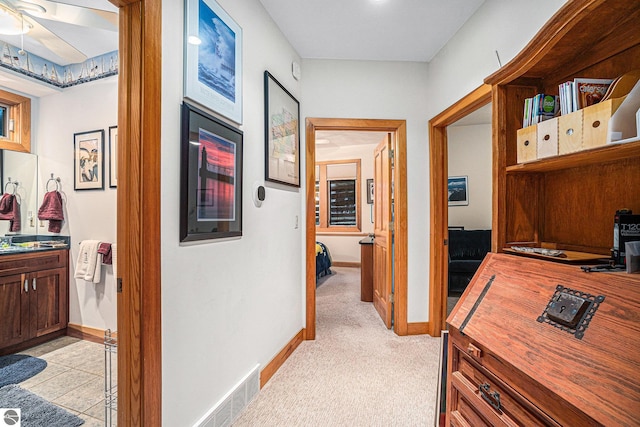 corridor featuring light colored carpet