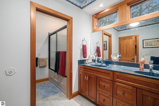 bathroom with tile patterned floors, vanity, and enclosed tub / shower combo