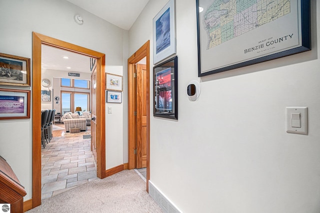 hall featuring light colored carpet