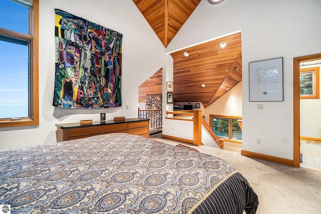 carpeted bedroom with high vaulted ceiling and wood ceiling