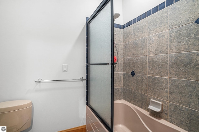 bathroom featuring toilet and enclosed tub / shower combo