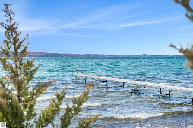 view of dock featuring a water and mountain view