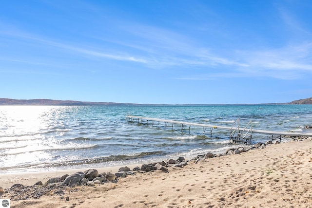 property view of water with a boat dock and a view of the beach