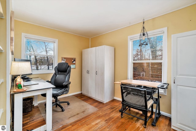 office area featuring light wood-type flooring and ornamental molding