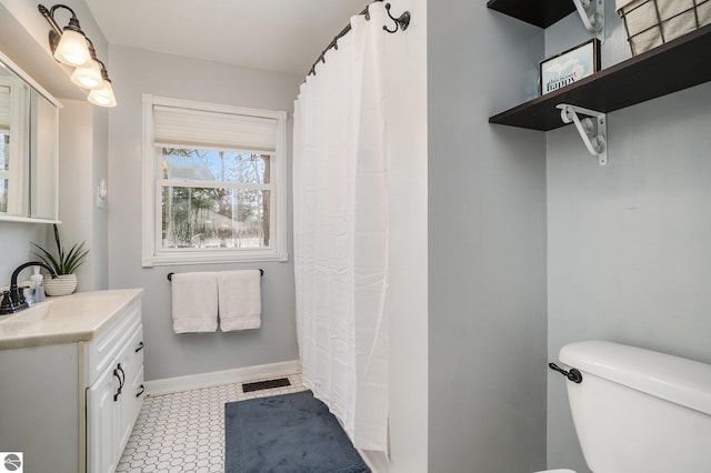 bathroom with tile patterned floors, vanity, and toilet