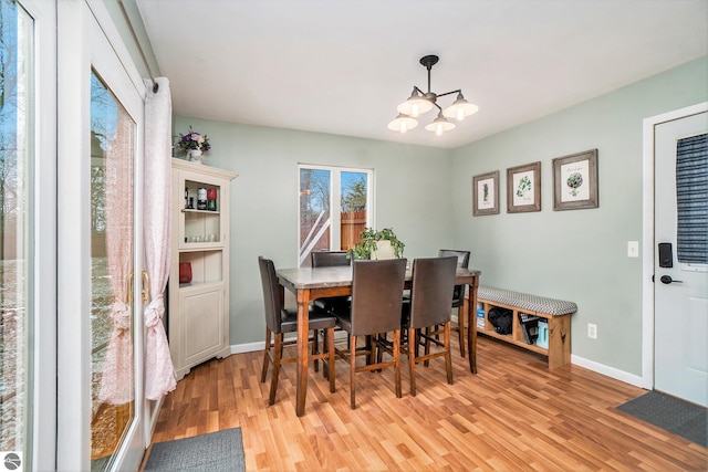 dining area featuring a chandelier and light hardwood / wood-style flooring