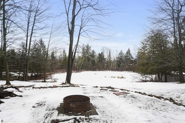 snowy yard featuring a fire pit