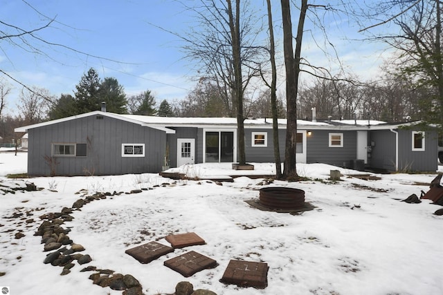 view of snow covered rear of property