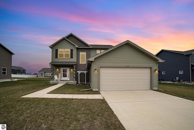 front of property featuring a lawn and a garage