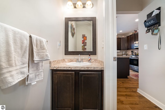 bathroom with vanity and wood-type flooring