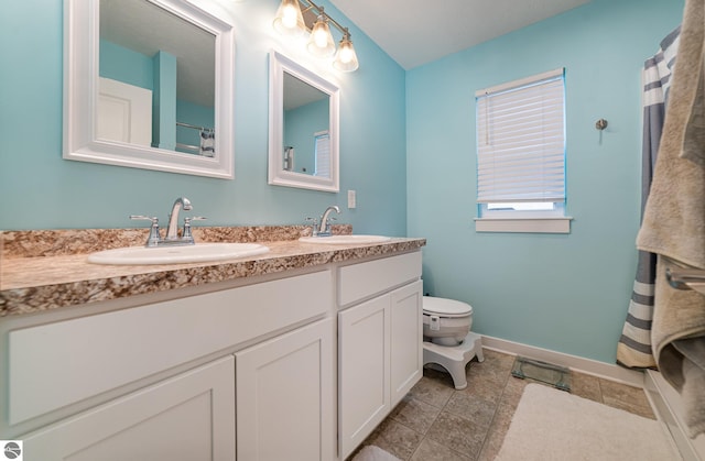 bathroom with tile patterned floors, vanity, and toilet