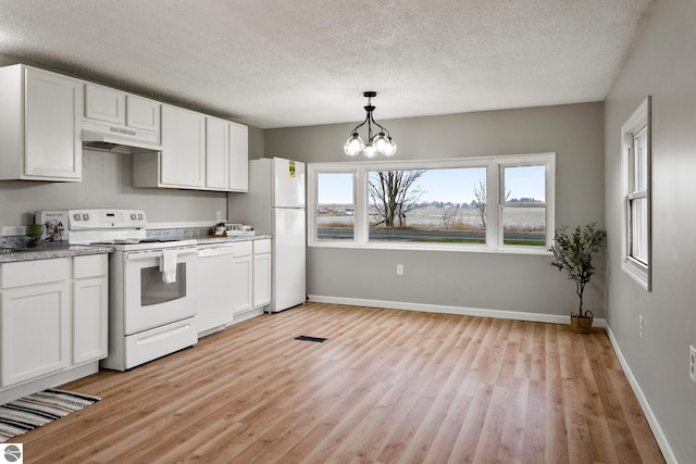 kitchen with white appliances, light hardwood / wood-style flooring, white cabinetry, and an inviting chandelier