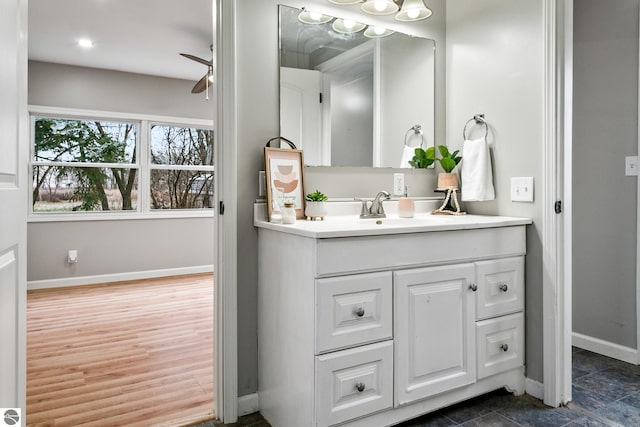 bathroom featuring ceiling fan, vanity, and hardwood / wood-style flooring