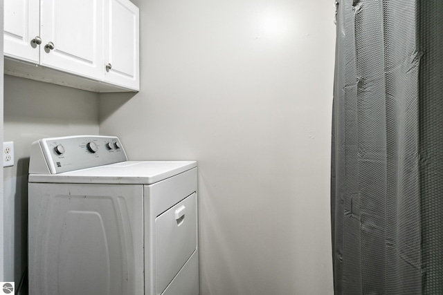 washroom featuring washer / clothes dryer and cabinets