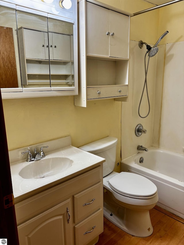 full bathroom with shower / bathing tub combination, hardwood / wood-style floors, vanity, and toilet