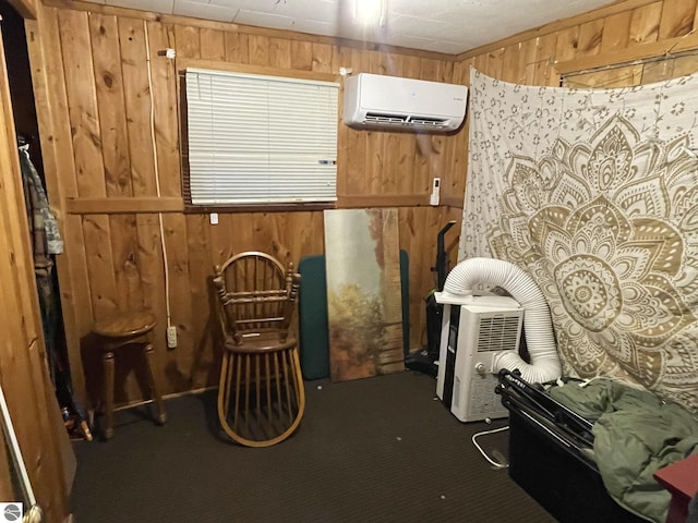 sitting room with a wall mounted air conditioner, dark colored carpet, and wooden walls