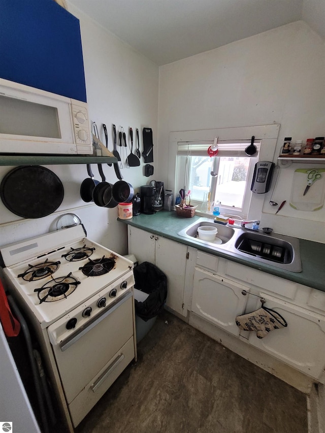 kitchen with white appliances, white cabinetry, dark wood-type flooring, and sink