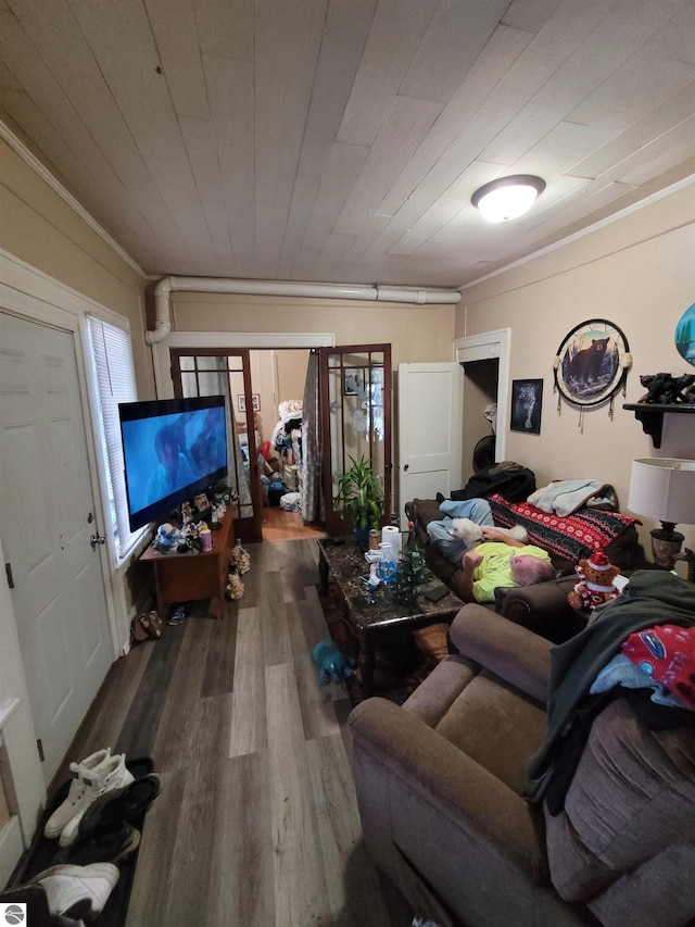 living room with hardwood / wood-style flooring, a healthy amount of sunlight, ornamental molding, and wood ceiling