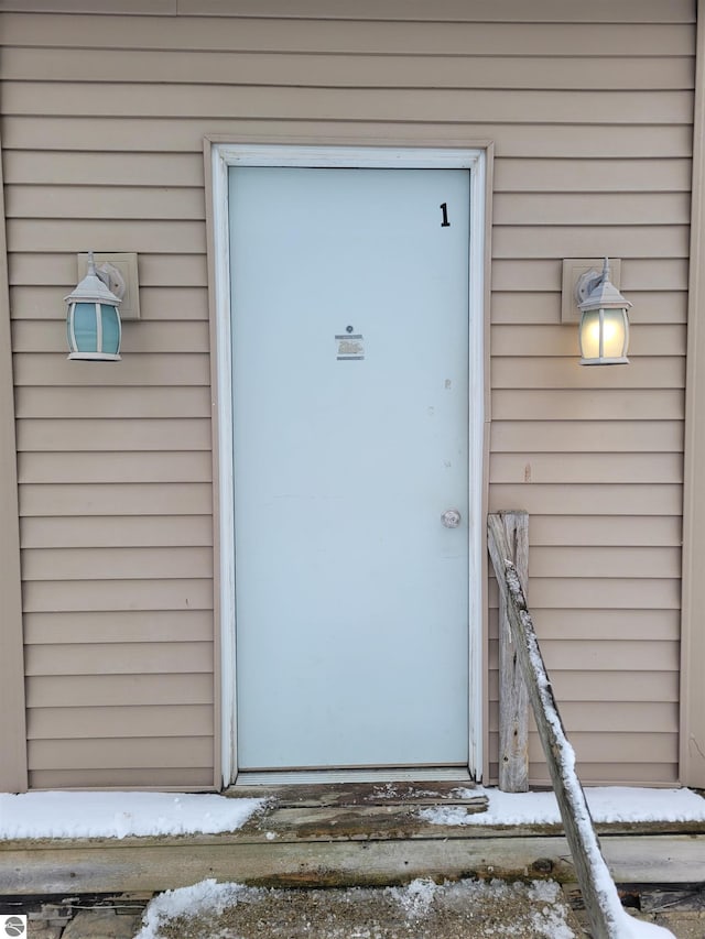 view of snow covered property entrance