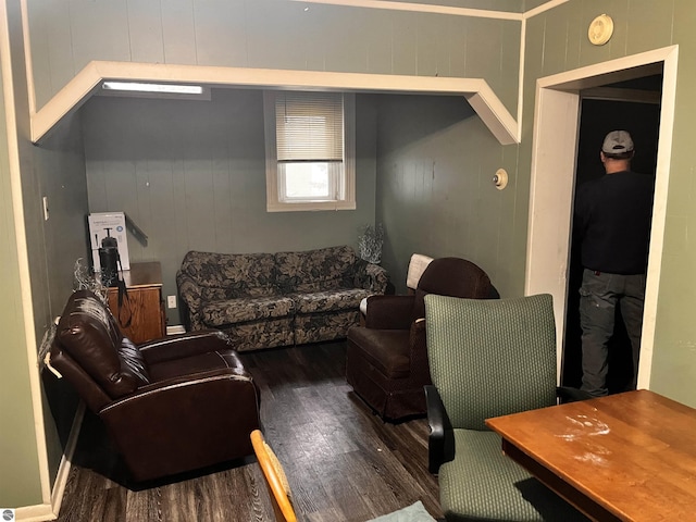 living room with wooden walls and hardwood / wood-style flooring