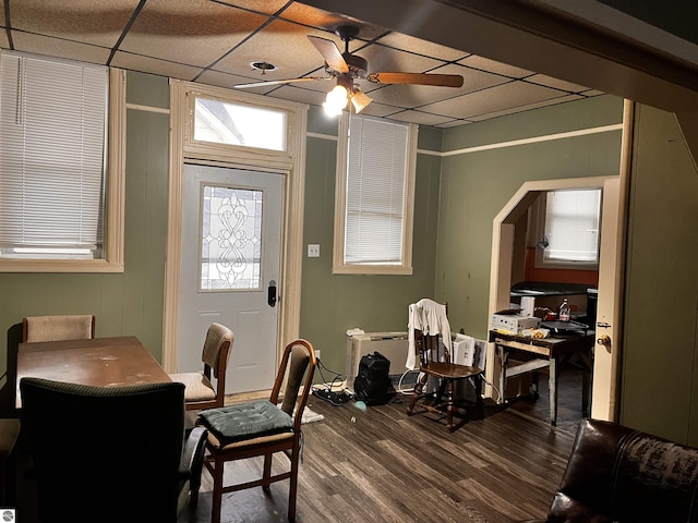 dining room featuring hardwood / wood-style flooring, ceiling fan, and a drop ceiling