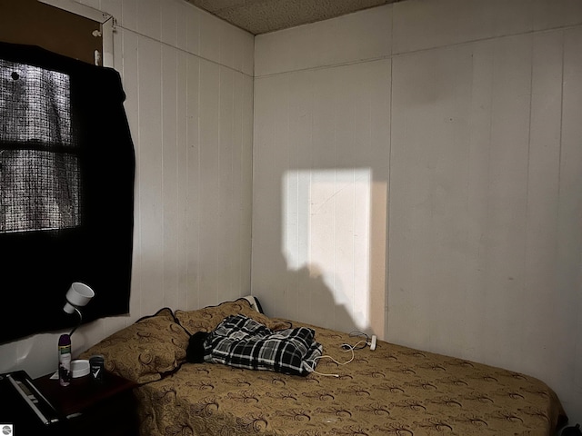 bedroom with wooden walls