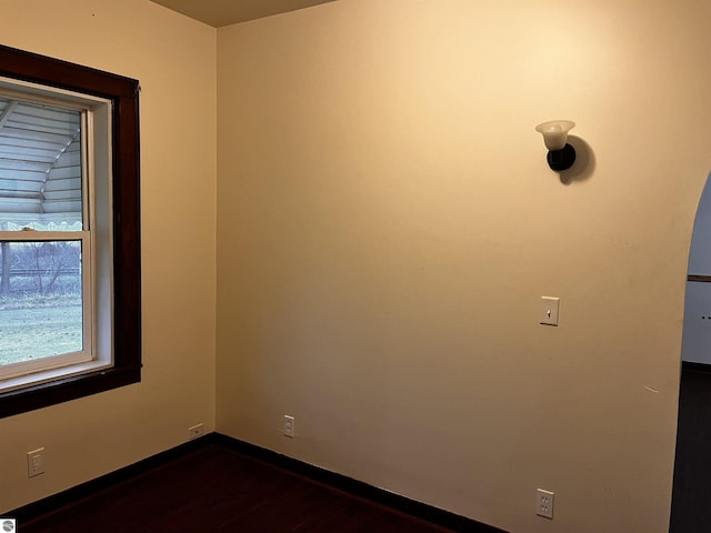 spare room featuring dark hardwood / wood-style flooring