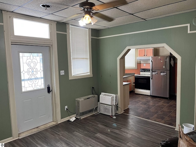 foyer entrance featuring a wall mounted AC, a paneled ceiling, dark hardwood / wood-style floors, and ceiling fan