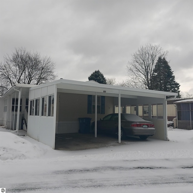 manufactured / mobile home featuring a carport and a sunroom