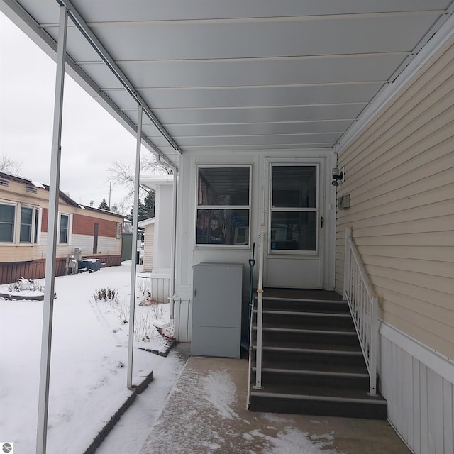 view of snow covered property entrance