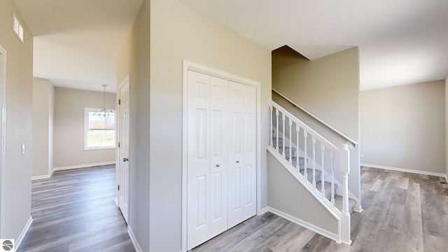 stairway featuring a chandelier and hardwood / wood-style floors