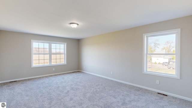 unfurnished room featuring light colored carpet