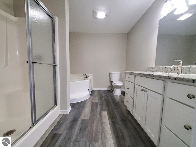 full bathroom featuring vanity, hardwood / wood-style flooring, toilet, and independent shower and bath