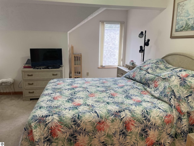 carpeted bedroom featuring lofted ceiling