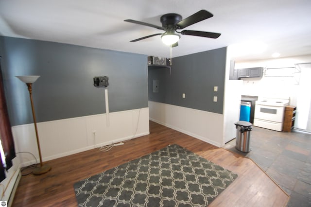 living room with dark hardwood / wood-style floors, a baseboard radiator, and ceiling fan