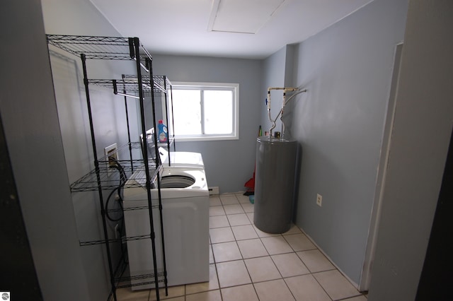 laundry area with washing machine and clothes dryer, water heater, and light tile patterned flooring