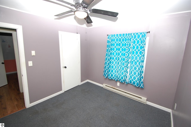 spare room featuring carpet flooring, baseboard heating, and ceiling fan