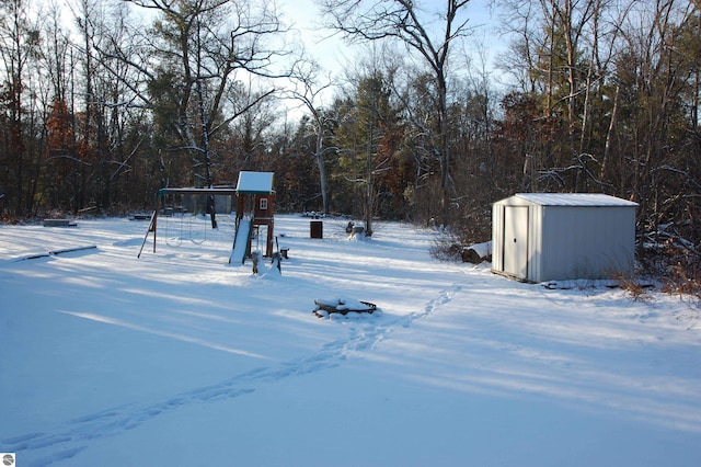 snowy yard with a storage unit