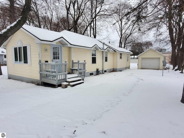 view of front of house featuring an outbuilding, a garage, and a deck