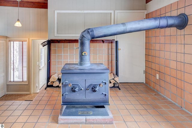 room details featuring a wood stove and wooden walls