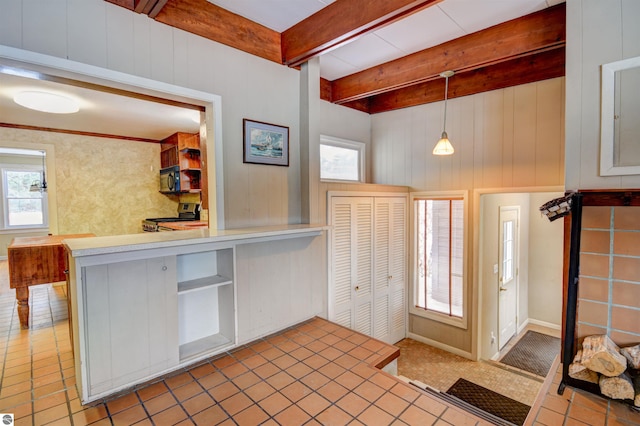 foyer with a wealth of natural light and beamed ceiling