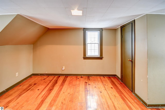 additional living space featuring hardwood / wood-style floors