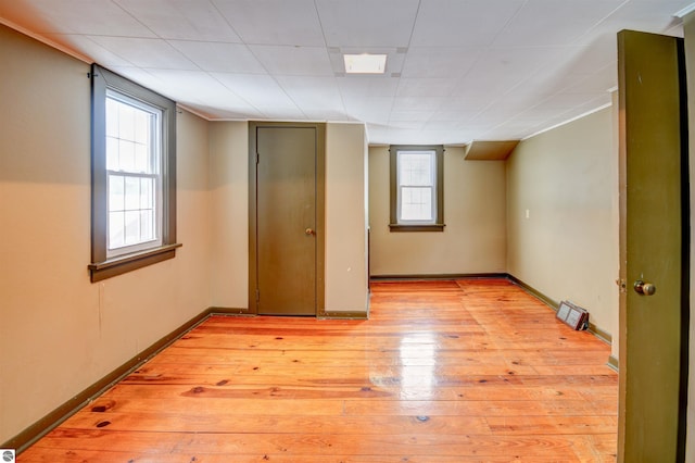 unfurnished room with light wood-type flooring